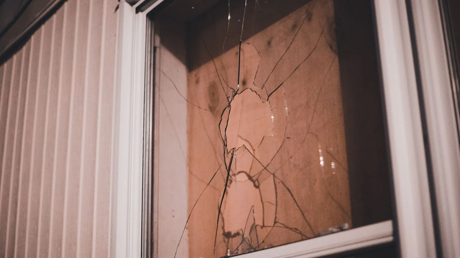 Cracked window pane showing why laminated glass and toughened safety glass matter