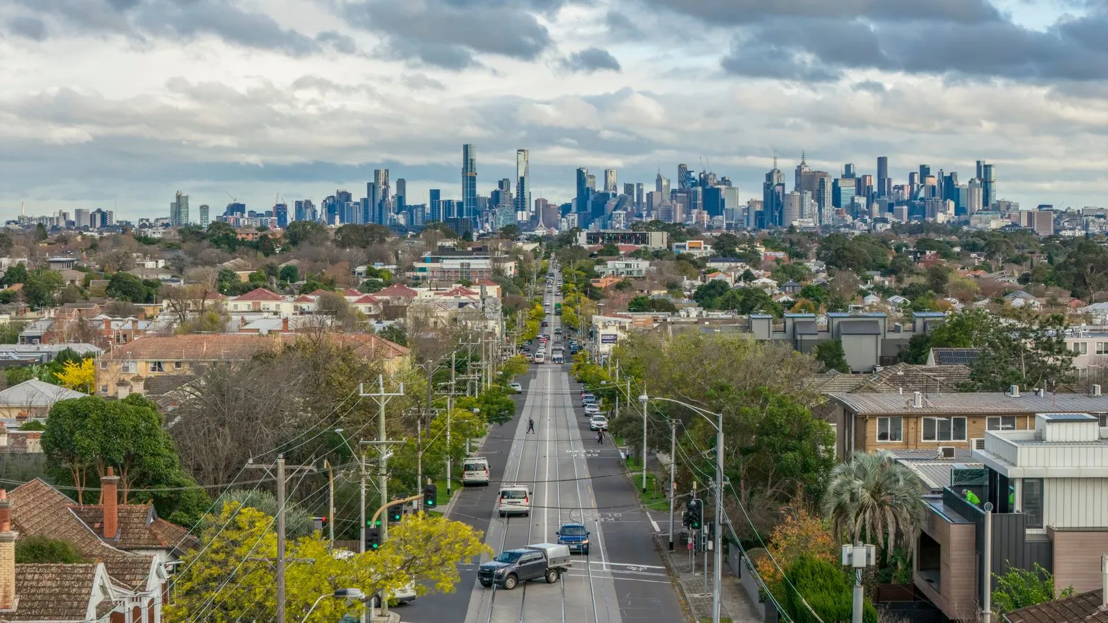 Busy suburban main road lined with houses, where soundproof windows help cut traffic noise